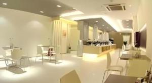 a room with white chairs and tables and a store at Jinjiang Inn Taiyuan Longtan Park in Taiyuan