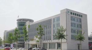 a large office building with a space needle at GreenTree Inn Tianjin Wuqing Distric Bohai Market in Tianjin