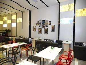 a restaurant with tables and chairs and windows at Lavande Hotel Wuhan Huanghelou Branch in Wuhan