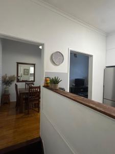 a kitchen and living room with a counter top and a refrigerator at Urbane on William in Rockhampton