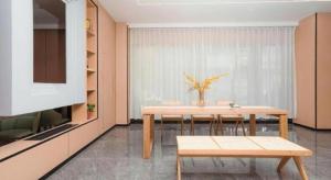 a dining room with a table and a kitchen at GreenTree Inn xinghua Middle Yingwu Road Express Hotel in Xinghua