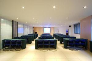 a conference room with blue tables and chairs at GreenTree Inn Fujian Fuzhou Software Park River View Business Hotel in Fuzhou