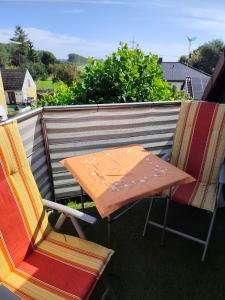 a table and two chairs sitting on a balcony at Krämer-Bude in Oberkrämer