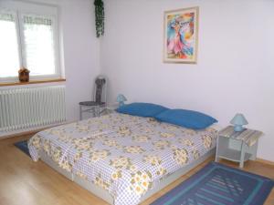 A bed or beds in a room at Viola Vendégház