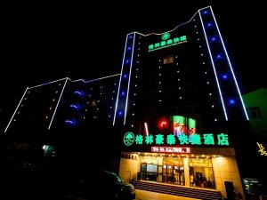 a building with blue and green lights on it at GreenTree Inn Xinjiang Uygur Autonomous Region Korla Bazhou Bus Terminal Beishan Road Express Hotel in Korla