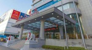 a building with a dog statue in front of it at Dalian Zhongshan Hotel in Dalian