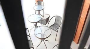 a group of chairs and tables with mirrors on them at Changsova Hotel in Rayong