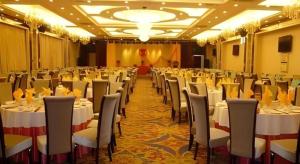 a banquet hall with white tables and chairs at Tianrun International Hotel in Dunhuang