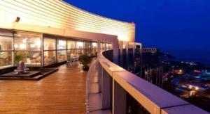 a large building with a balcony at night at Holiday Inn Hotel & Suites Jiaxing Hangzhou Bay By IHG in Jiaxing
