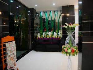 a display window of a flower shop with a vase of flowers at Ido Boutique Suite in Hat Yai