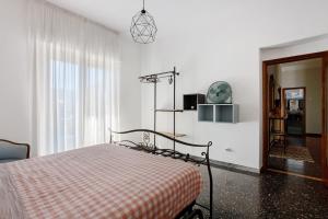 a bedroom with a bed with a checkered blanket at Ca' Montello Apartment in La Spezia