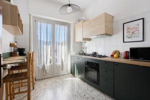 a kitchen with a stove top oven next to a window at Ca' Montello Apartment in La Spezia