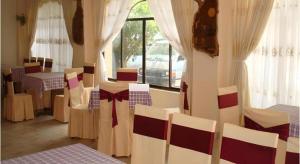 a room with chairs and tables and a window at Cao Nguyen Hotel in Buon Ma Thuot
