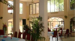 a dining room with tables and chairs and windows at Cao Nguyen Hotel in Buon Ma Thuot +156 photos