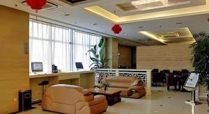 a lobby with two couches and a table and chairs at Starway Hotel Hongqiao Junction Center Branch in Shanghai