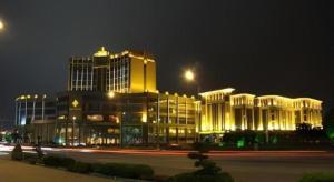 a large building with lights in front of it at night at Changshu Jinling Tianming Grand Hotel in Suzhou