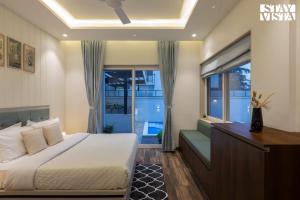 イガットプリにあるStayVista at Amara Palmsのベッドと窓のある寝室