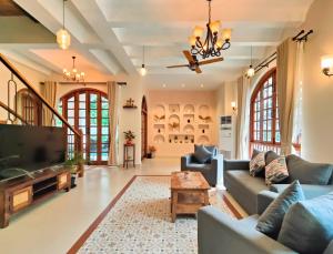 a living room with a couch and a tv at Villa Laz, Parra close to calangute- Pool,Jacuzzi,Cook in Parra