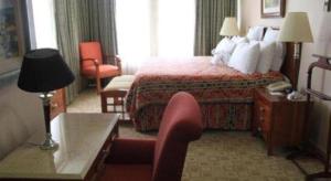 a hotel room with a bed and a chair at Hotel Honduras Maya in Tegucigalpa +38 photos
