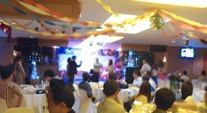 a group of people sitting at tables in a room at Ubon Hotel in Ubon Ratchathani