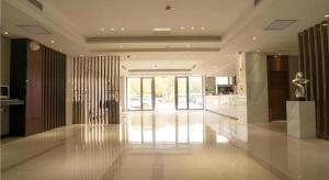 a large room with a lobby with glass walls at City Comfort Inn Wuhan High Speed Railway Station in Wuhan