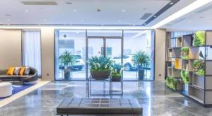 a lobby with a couch and plants in a building at Home Inn Selected Xiamen University Zhongshan Road in Xiamen