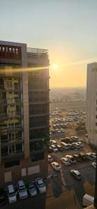 a parking lot with cars parked outside of a building at Sheeva Backpacker Hostel in Abu Dhabi
