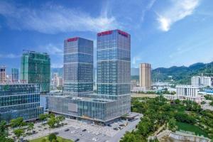 a group of tall buildings in a city at Shunshine International Hotel Xiangxi in Ganziping
