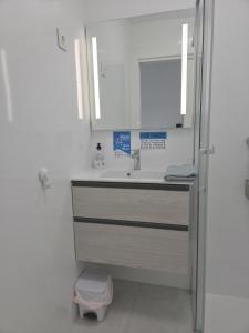 a bathroom with a sink and a mirror at Apartment with stunning views of Bahia Hornillo & Pool - Aguilas in Águilas