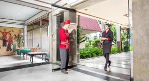 a woman standing in front of a building at Sahid Kawanua Hotel in Manado +171 photos