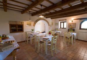 a dining room with white tables and chairs at B&B Cristina in Porto Recanati