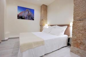 a bedroom with a white bed and a building at Le 10 - Nice Massena in Nice