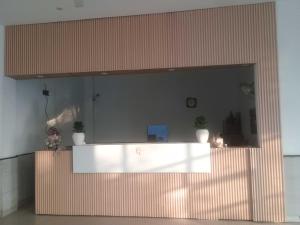 a lobby with a white counter in a building at Hotel O Sky in Dādri