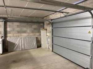 a garage with two garage doors in a room at Maison Romarin in Le Boulou +1 photo
