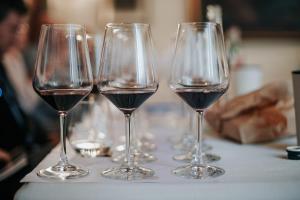 three glasses of red wine sitting on a table at Agriturismo La Fattoria di Capezzana in Carmignano
