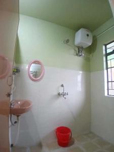 a bathroom with a sink and a mirror at Siej Homestay in Cherrapunji