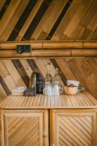 a shelf in a wooden cabin with a coffee maker at Nirvana Bamboo House by Arcada Bali in Selat