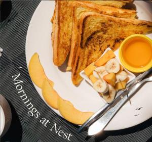 a plate with toast and slices of bread and a knife at Qubed Hotel Nathiagali in Nathia Gali