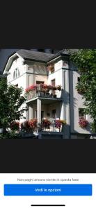 a picture of a building with flower boxes on it at Tirano stazioni flow rooms in Tirano