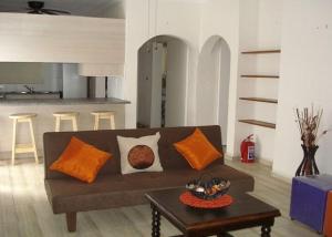 a living room with a couch and a table at Oswald Ramgate Beach in Margate