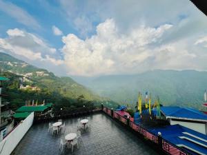 a view of a balcony with tables and chairs at The Continental Near Mg Marg in Gangtok