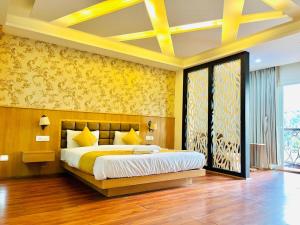 a bedroom with a large bed with yellow walls at The Continental Near Mg Marg in Gangtok +20 photos