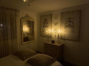 a bedroom with a bed and two lights on the wall at La Grange in Savenay