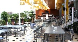 a restaurant with tables and chairs in a building at Grant Hotel Subang in Subang