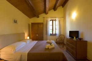 a bedroom with a large bed with a teddy bear on it at B&B Cristina in Porto Recanati