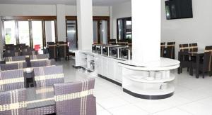 a waiting room with chairs and a table and a mirror at Grand Mutiara Hotel in Pangandaran
