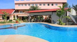a large swimming pool in front of a building at Coco Mango's Place in Panglao +149 photos