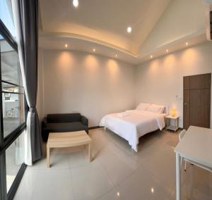 a white bedroom with a bed and a couch at D sleep Villa Chiangmai in Chiang Mai +27 photos