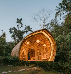 a wooden iguana house in a forest at Nirvana Bamboo House by Arcada Bali in Selat