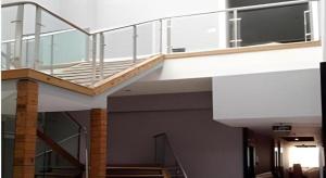 a staircase in a building with a glass railing at Fairyland Hotel Kunming Tuodong Branch in Kunming